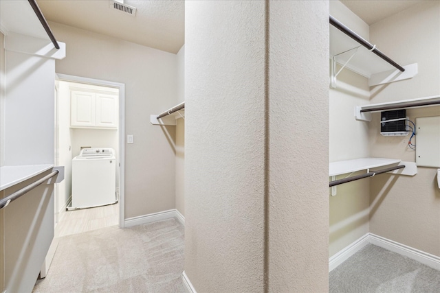 35 Daffodil Meadow Pl, Tomball, TX 77375 - walk in closet featuring washer / clothes dryer and light colored carpet