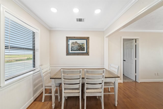 109 Fm-2031, Matagorda, TX 77457 - dining room with baseboards, wood finished floors, crown molding, and recessed lighting