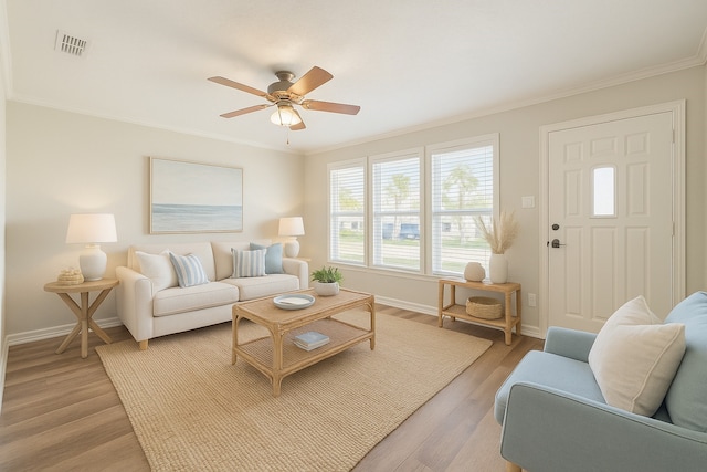 7205 Yucca Dr, Galveston, TX 77551 - living room with ornamental molding, baseboards, ceiling fan, and light wood-style flooring