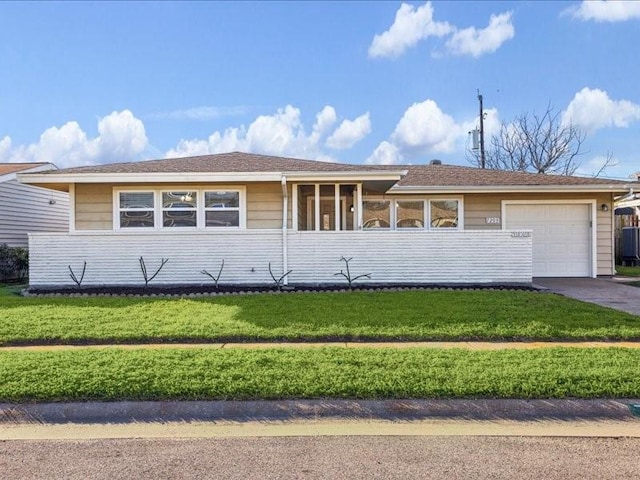 7205 Yucca Dr, Galveston, TX 77551 - ranch-style home with a garage, driveway, and a front yard