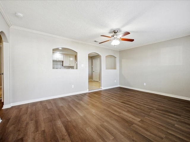 7205 Yucca Dr, Galveston, TX 77551 - spare room with arched walkways, a ceiling fan, dark wood finished floors, baseboards, and ornamental molding