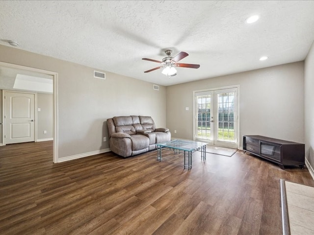 7205 Yucca Dr, Galveston, TX 77551 - living room featuring wood finished floors, ceiling fan, baseboards, a textured ceiling, and french doors
