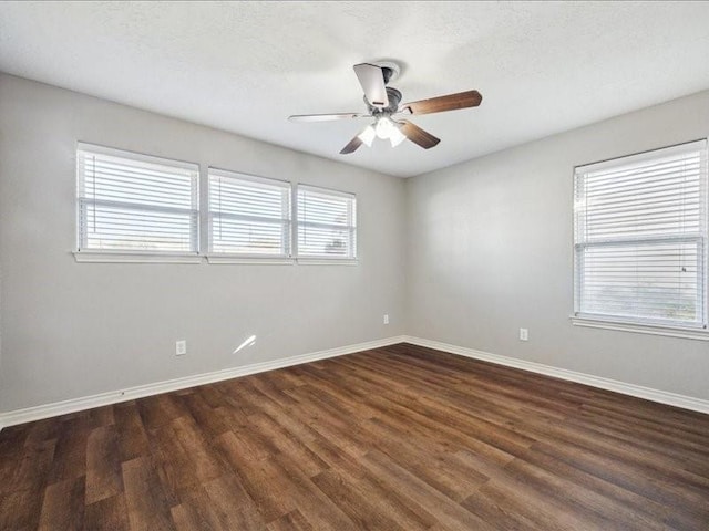7205 Yucca Dr, Galveston, TX 77551 - unfurnished room featuring dark wood-type flooring, a ceiling fan, and baseboards