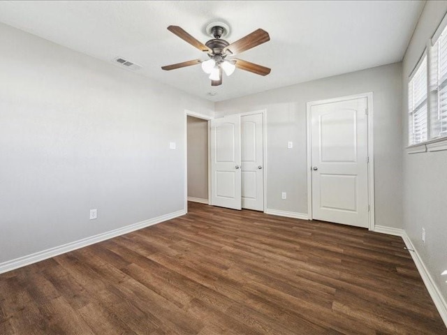 7205 Yucca Dr, Galveston, TX 77551 - unfurnished bedroom featuring wood finished floors, baseboards, and a ceiling fan