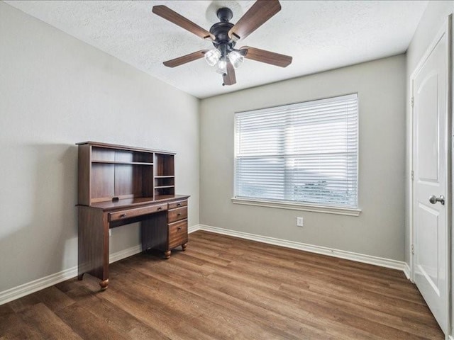 7205 Yucca Dr, Galveston, TX 77551 - unfurnished office featuring wood finished floors, plenty of natural light, a ceiling fan, baseboards, and a textured ceiling