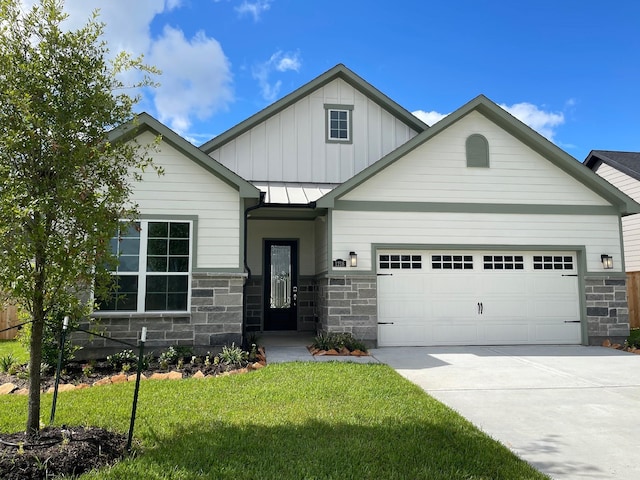 1218 Hidden Oaks Dr, Tomball, TX 77375 - view of front of property with a garage, stone siding, concrete driveway, and a front lawn