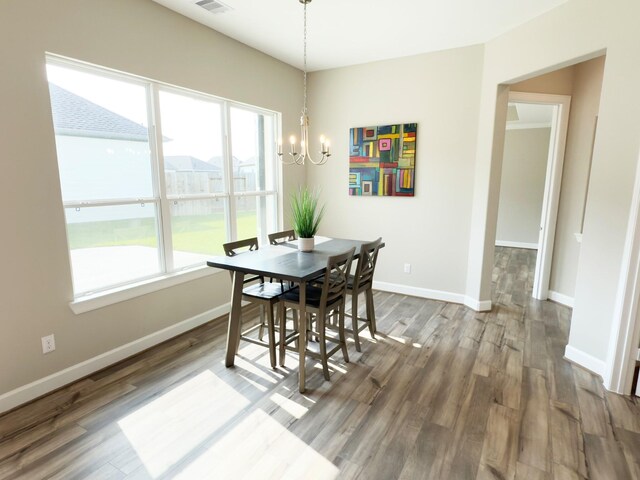 1218 Hidden Oaks Dr, Tomball, TX 77375 - dining room with a chandelier, wood finished floors, and baseboards