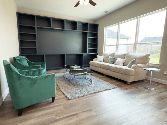 1218 Hidden Oaks Dr, Tomball, TX 77375 - living area featuring a ceiling fan, baseboards, and wood finished floors