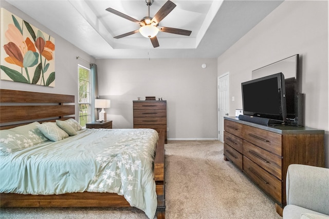 1608 Lark St, Alvin, TX 77511 - bedroom featuring a raised ceiling, light carpet, baseboards, and a ceiling fan