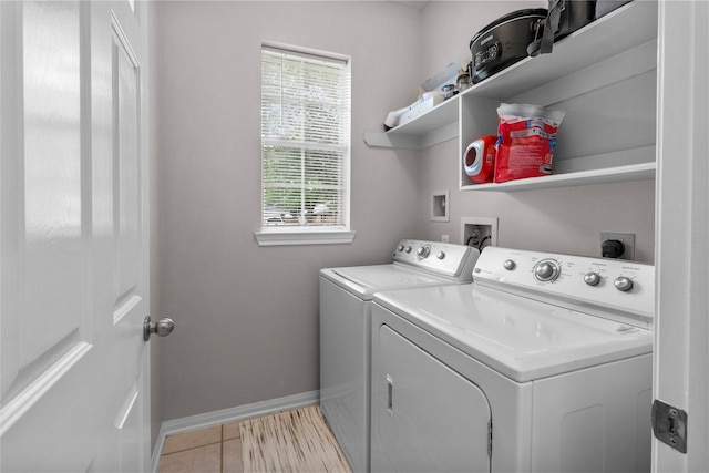 1608 Lark St, Alvin, TX 77511 - laundry area featuring washing machine and dryer, baseboards, and light tile patterned floors