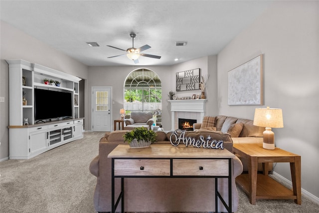 1608 Lark St, Alvin, TX 77511 - carpeted living area featuring a ceiling fan, a tiled fireplace, and baseboards