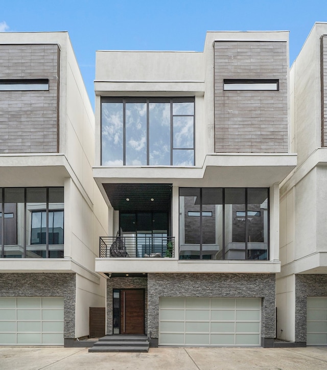 819 W 24th St Unit C, Houston, TX 77008 - view of front of home with an attached garage, stucco siding, and a balcony