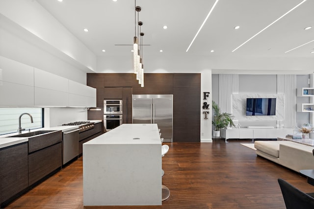 819 W 24th St Unit C, Houston, TX 77008 - kitchen featuring appliances with stainless steel finishes, modern cabinets, open floor plan, dark brown cabinets, and recessed lighting