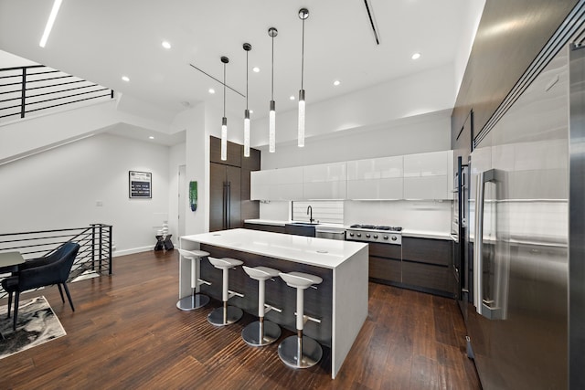 819 W 24th St Unit C, Houston, TX 77008 - kitchen with appliances with stainless steel finishes, modern cabinets, a kitchen island, light countertops, and dark wood-style floors