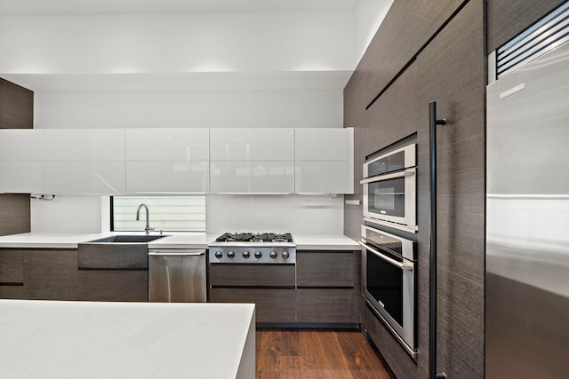 819 W 24th St Unit C, Houston, TX 77008 - kitchen with appliances with stainless steel finishes, a sink, modern cabinets, dark wood finished floors, and light countertops