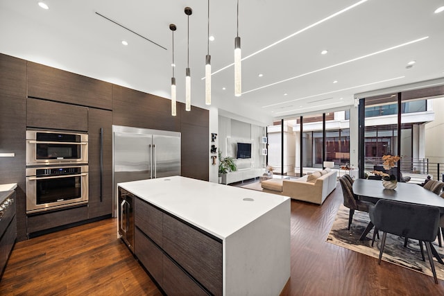 819 W 24th St Unit C, Houston, TX 77008 - kitchen featuring modern cabinets, dark wood-style floors, dark brown cabinets, a kitchen island, and expansive windows