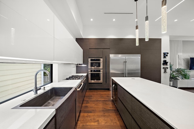 819 W 24th St Unit C, Houston, TX 77008 - kitchen featuring modern cabinets, appliances with stainless steel finishes, light countertops, dark brown cabinets, and a sink