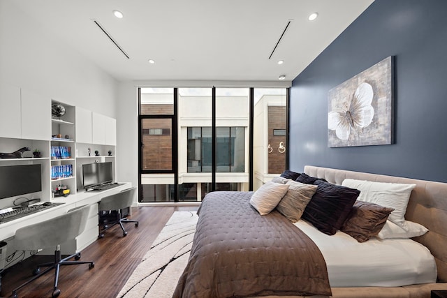 819 W 24th St Unit C, Houston, TX 77008 - bedroom with expansive windows, dark wood-type flooring, and recessed lighting