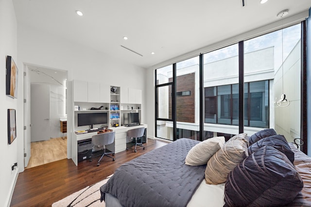 819 W 24th St Unit C, Houston, TX 77008 - bedroom with wood finished floors, an office area, recessed lighting, and a wall of windows