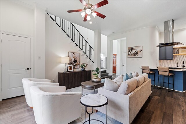 3615 Hempstead Villa Dr, Houston, TX 77008 - living area featuring stairway, a ceiling fan, dark wood finished floors, ornamental molding, and recessed lighting