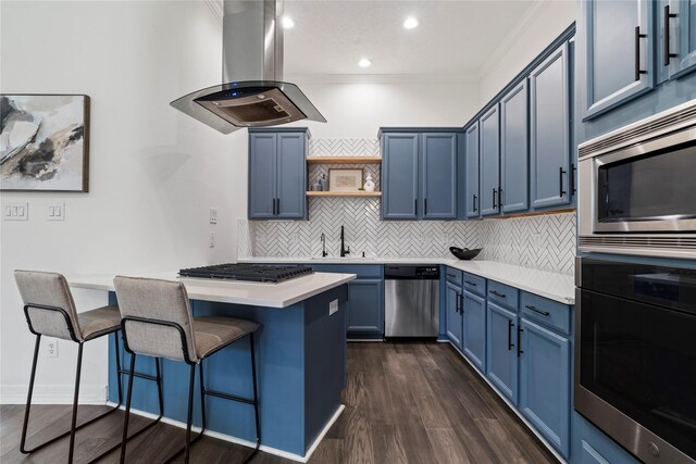 3615 Hempstead Villa Dr, Houston, TX 77008 - kitchen with appliances with stainless steel finishes, blue cabinetry, island exhaust hood, a kitchen bar, and open shelves