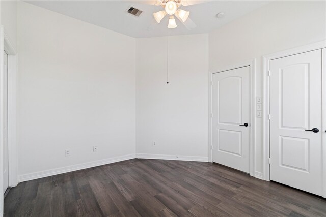 3615 Hempstead Villa Dr, Houston, TX 77008 - unfurnished bedroom with dark wood-type flooring, baseboards, and ceiling fan