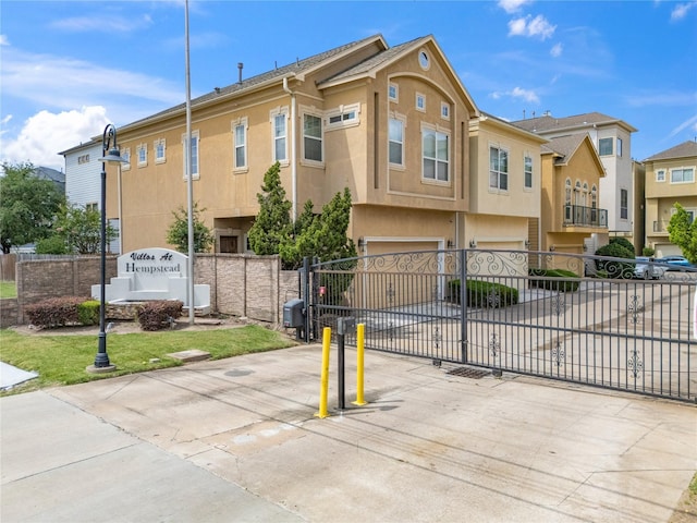 3615 Hempstead Villa Dr, Houston, TX 77008 - view of front of home featuring a garage, stucco siding, concrete driveway, and a residential view