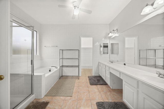 8506 Regalbrook Dr, Houston, TX 77095 - full bath with tile patterned floors, a bath, double vanity, ceiling fan, and a spacious closet