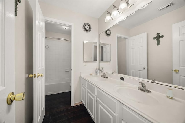 8506 Regalbrook Dr, Houston, TX 77095 - bathroom with wood finished floors, double vanity, bathing tub / shower combination, and baseboards