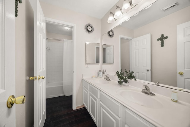 8506 Regalbrook Dr, Houston, TX 77095 - full bath featuring wood finished floors, double vanity, and shower / bath combo with shower curtain