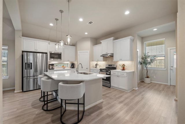 4607 Primrose Valley Ln, Fulshear, TX 77441 - kitchen with appliances with stainless steel finishes, a sink, white cabinetry, light countertops, and decorative backsplash