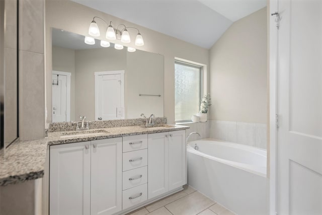 4607 Primrose Valley Ln, Fulshear, TX 77441 - bathroom featuring double vanity, a garden tub, tile patterned floors, and lofted ceiling
