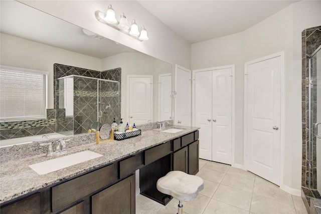 24210 Leonforte Dr, Richmond, TX 77406 - full bathroom featuring a stall shower, double vanity, tile patterned floors, and a closet