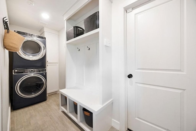 10310 Helmsdale St, Houston, TX 77043 - mudroom featuring stacked washing machine and dryer and light wood-style floors