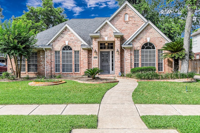 6614 Cypress Village Dr, Sugar Land, TX 77479 - traditional home featuring brick siding and a shingled roof