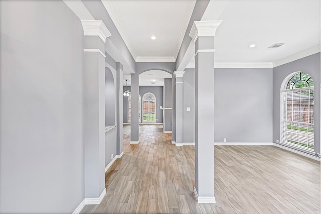 6614 Cypress Village Dr, Sugar Land, TX 77479 - hallway featuring arched walkways, ornate columns, ornamental molding, light wood-type flooring, and baseboards