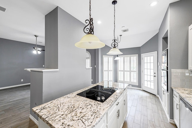 6614 Cypress Village Dr, Sugar Land, TX 77479 - kitchen featuring appliances with stainless steel finishes, a ceiling fan, white cabinetry, light wood-type flooring, and lofted ceiling