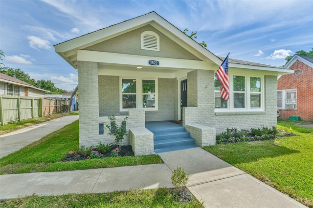 1522 Munger St, Houston, TX 77023 - shotgun-style home featuring brick siding and a porch