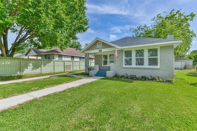 1522 Munger St, Houston, TX 77023 - view of front of home featuring brick siding, a porch, a chimney, and roof with shingles