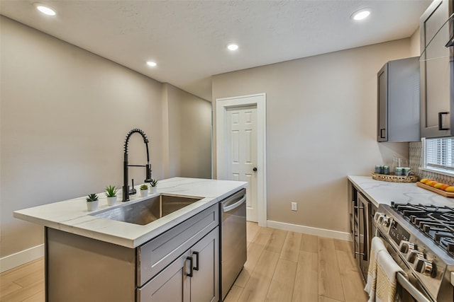 1522 Munger St, Houston, TX 77023 - kitchen with appliances with stainless steel finishes, gray cabinets, baseboards, light wood-type flooring, and recessed lighting