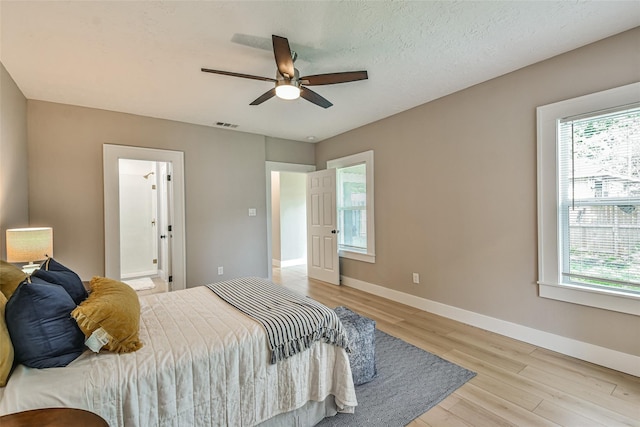 1522 Munger St, Houston, TX 77023 - bedroom featuring light wood-style flooring, baseboards, and ceiling fan