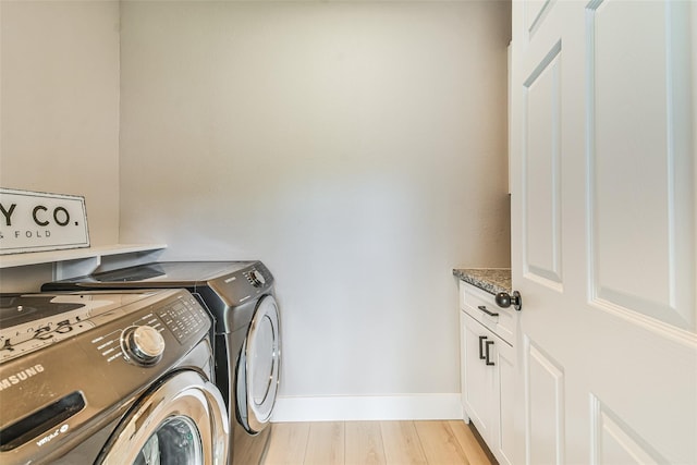 1522 Munger St, Houston, TX 77023 - washroom with cabinet space, washer and dryer, light wood-type flooring, and baseboards