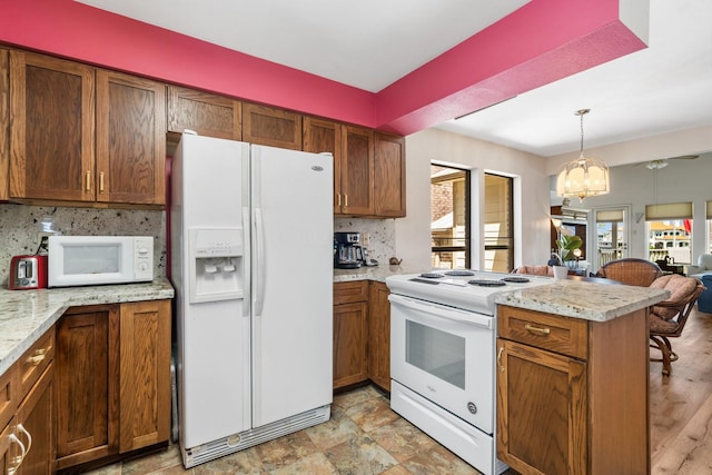 112 Cove Pt, Montgomery, TX 77356 - kitchen with white appliances, backsplash, and brown cabinets