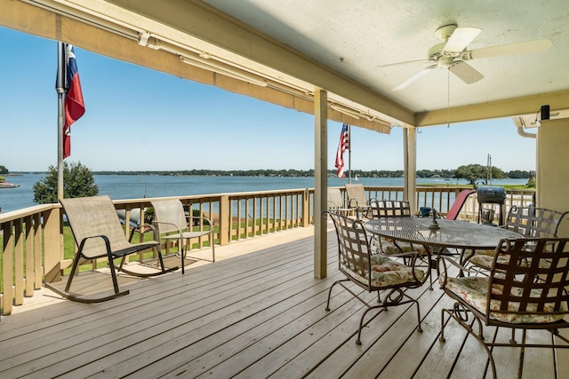 112 Cove Pt, Montgomery, TX 77356 - wooden terrace featuring ceiling fan, a water view, and outdoor dining area