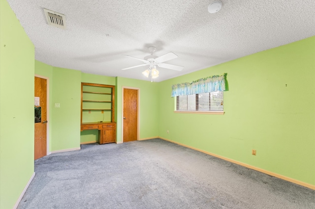 1211 Sycamore Ln, Houston, TX 77339 - unfurnished bedroom with carpet, baseboards, a textured ceiling, a ceiling fan, and a desk