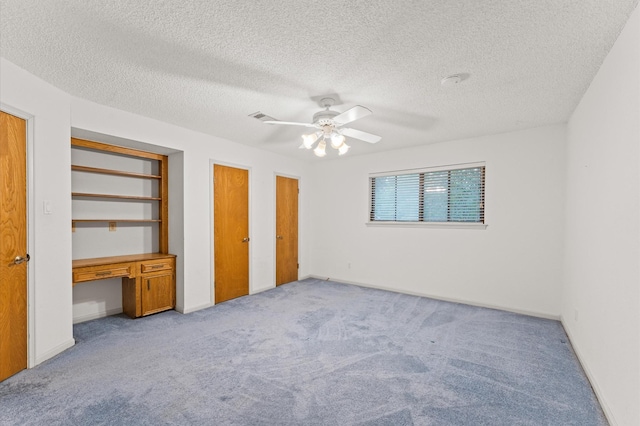 1211 Sycamore Ln, Houston, TX 77339 - unfurnished bedroom with carpet floors, ceiling fan, a textured ceiling, and baseboards