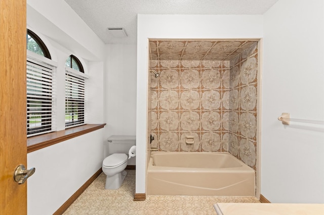 1211 Sycamore Ln, Houston, TX 77339 - bathroom with toilet, baseboards, and shower / tub combination