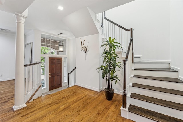 2007 Indiana St, Houston, TX 77019 - entrance foyer featuring light wood-style flooring, stairway, baseboards, decorative columns, and recessed lighting