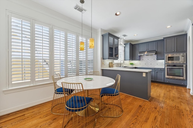 2007 Indiana St, Houston, TX 77019 - dining room featuring light wood-type flooring, crown molding, baseboards, and recessed lighting