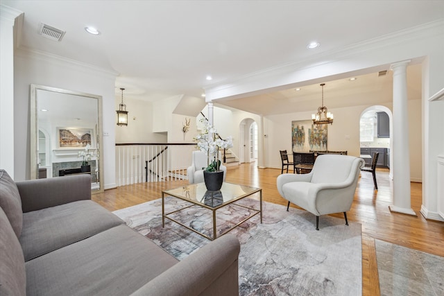 2007 Indiana St, Houston, TX 77019 - living room featuring arched walkways, crown molding, a chandelier, recessed lighting, and light wood-type flooring